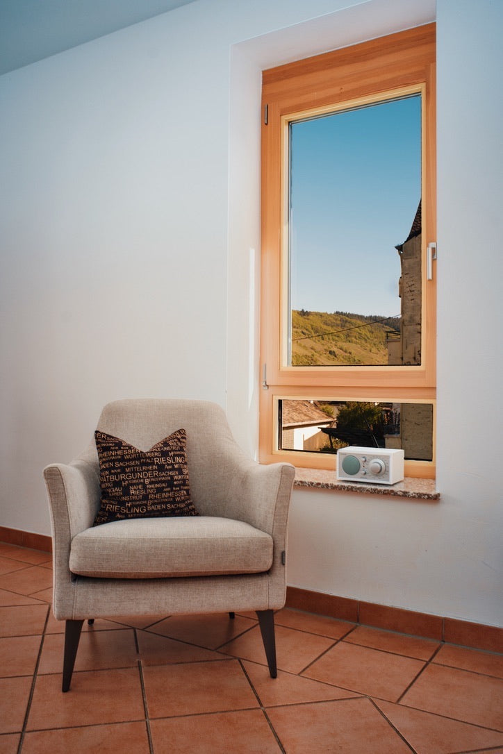 Sitzecke mit Sessel und Blick durchs Fenster auf die Weinberge – Ferienwohnung Arns, Reil an der Mosel